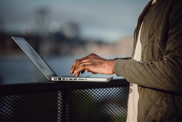 a person typing on a laptop